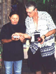 Photo of John and lady bargaining using calculators.
